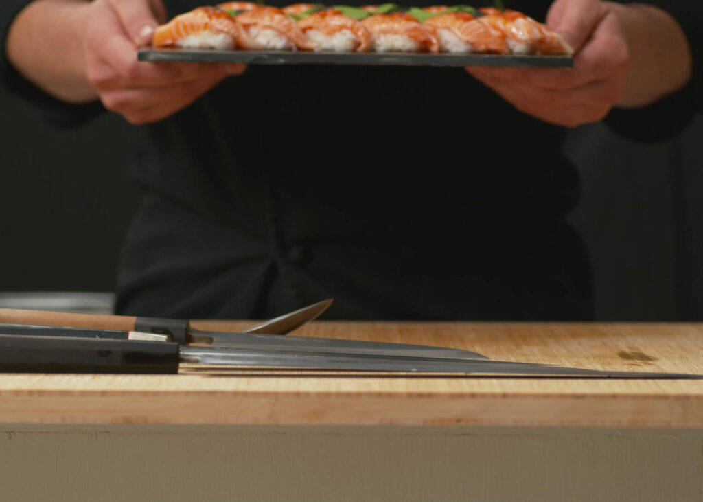 Chef presenting a platter of sushi