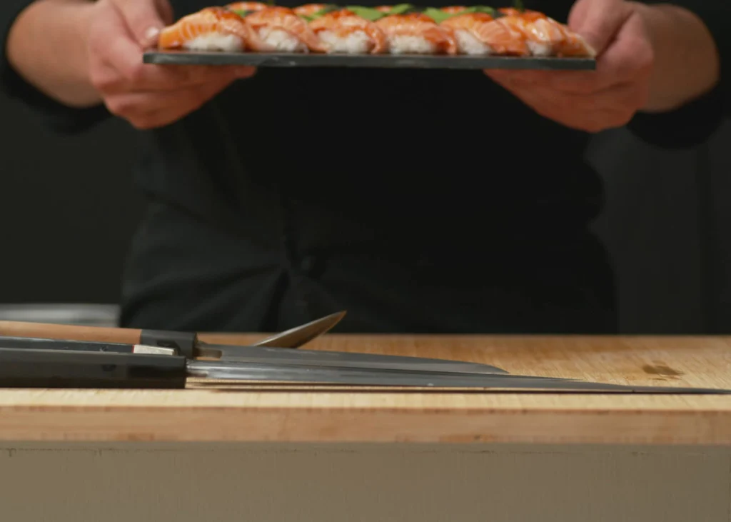 Chef presenting a platter of sushi