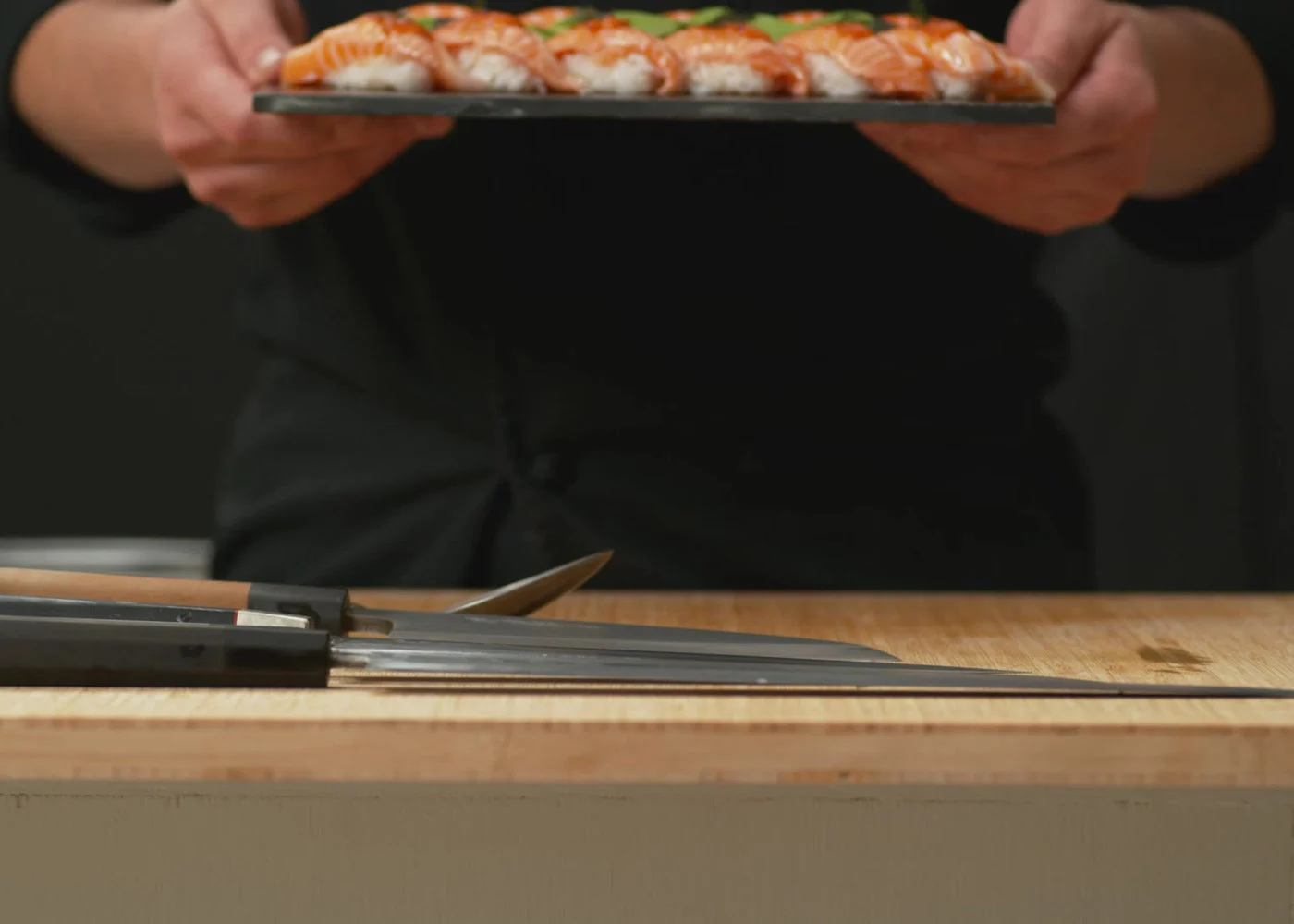 Chef presenting a platter of sushi, the kind of shared spread used for catering in Salisbury, Brisbane
